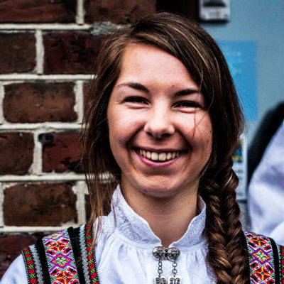 Young Norwegian Woman Wearing the Traditional Costume on the Bryggen Dock in Bergen