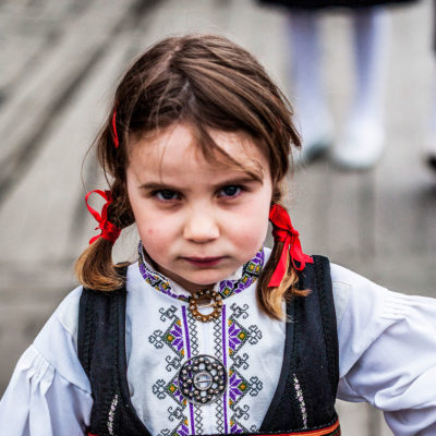 Norwegian Child Wearing the Traditional Costume on the Bryggen Dock in Bergen