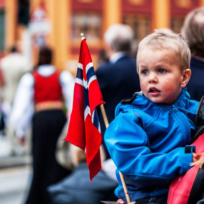 Child in the Arms of his Mother Attending the Festivities for the Constitution Day in the Marketplace of Bergen