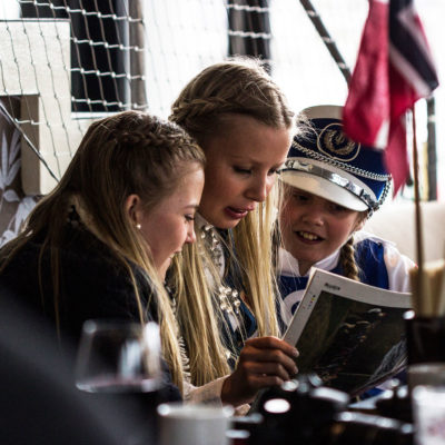 Children Reading a Magazine in a Bar of Svolvær, on the Lofoten Islands